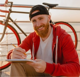 A boy with a bike and a sketch pad